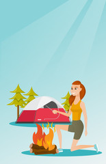 Poster - Young caucasian white woman with a wooden stick in his hand sitting near the campfire and enjoying the atmosphere. Smiling woman making the campfire. Vector cartoon illustration. Vertical layout.