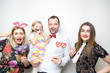 young family posing party photo booth props baby girl plain background studio