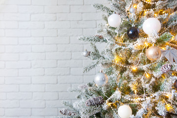 white christmas tree with gold and silver ornaments and balls.
