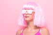 © Tierney - Beautiful woman in a bright pink wig on a pink background