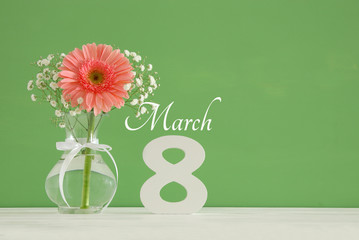 Wall Mural - Image of International women day concept with beautiful flower in the vase on wooden table.