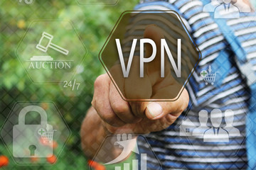 Elderly businessman, the farmer chooses  a VPN on the touch screen. Virtual private network web tag.Сoncept internet technology.