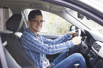 Wall Mural - young adult driving the car