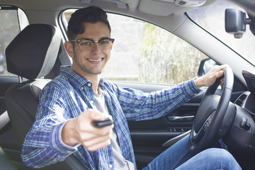 Wall Mural - young adult driving the car