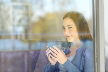 Wall Mural - Woman looking forward through a window