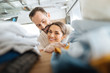 © zinkevych - Love minute. Pretty loving young couple doing laundry while laughing and hugging