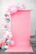 Pink background decorated blue balloons studio
