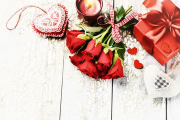 Bouquet of red roses with decorative hearts and presents. St Valentine's day concept