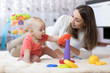 © Oksana Kuzmina - little child boy and his mommy play with toys at home