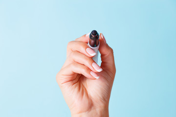 Female hand with a black marker. The concept of writing or signing on a flip chart