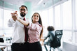 © Svyatoslav Lypynskyy - A pair of workers are dancing in office. Relaxing during busy day.