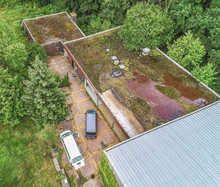 Aerial View Of The Old-fashioned Overgrown Roof Of A Former Sports Hall