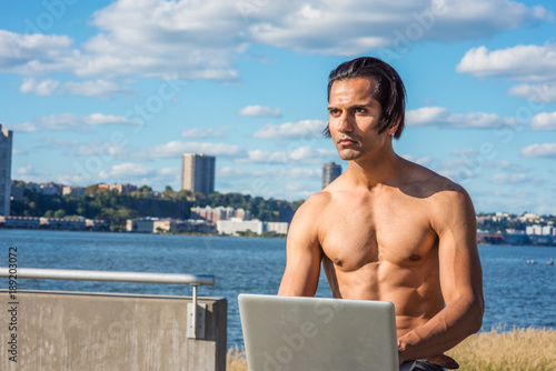 500px x 334px - Young East Indian American Man, half naked, sitting at park ...
