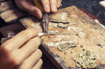 Wall Mural - jeweler produces gold jewelry in the workshop