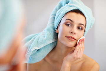 Young woman standing in bathroom in the morning