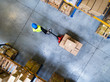 Male warehouse worker pulling a pallet truck.