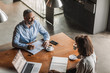© LUMINA IMAGES - Businessman and businesswoman working together at coffee shop.