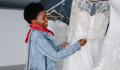 Wall Mural - Woman shopping for wedding outfit in bridal boutique