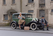 Two Models Get Dressed Up In 1930's Style Vintage Fashion Clothes And Act The Role Of The Gangster Duo Bonnie And Clyde.