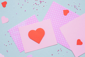 Valentines day background. Valentine card with heart and craft paper on the blue background