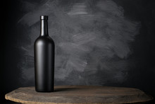 Red Wine Bottle On A Wooden Background