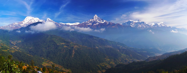 Annapurna mountain range landscape on sunrise with famous summits Annapurna Main, Annapurna South, Machapuchare and Manaslu Himal. Nepal, Himalayas, horizontal panoramic view on misty sunrise