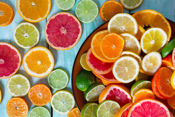 Poster - citrus fruit slices on turquoise background