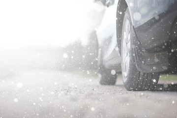 A car on a rural road in the first autumn snow. The first winter