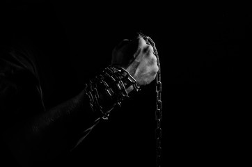 Wall Mural - Hands are chained in chains isolated on black background