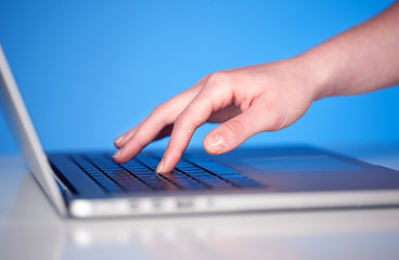 Close up of hand pressing keyboard buttons