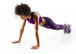 © Romario Ien - Strong girl doing push up. Photo of sporty african girl doing exercising isolated on white background. Strength and motivation
