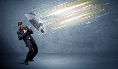 Wall Mural - Business man defending light beams with umbrella concept