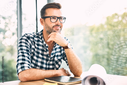 Fotografía Thoughtful designer sitting at desk in modern office