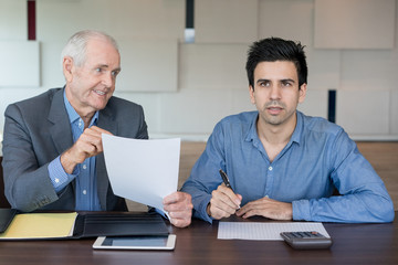 Wall Mural - Confused man calculating budget at meeting