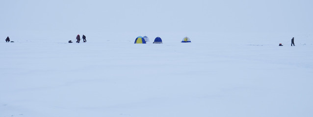  fishermens on the ice.  fishing in the winter