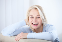 Active Beautiful Middle-aged Woman Smiling Friendly And Looking In Camera. Woman's Face Closeup. Realistic Images Without Retouching With Their Own Imperfections. Selective Focus.