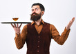 Barman with strict face serves cognac. Luxury beverage concept.