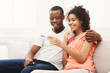 Young african-american couple happy about results of pregnancy test