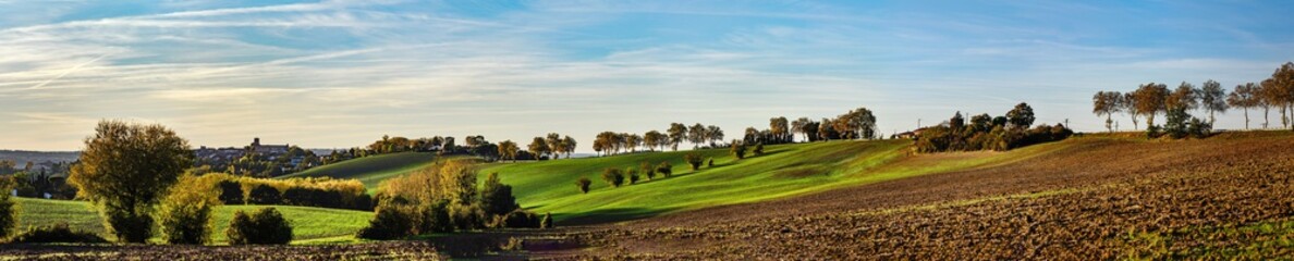 Beautiful green and yellow hills sunset panoramic view with shadows