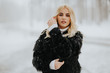 © BGStock72 - Blonde woman outside in snow winter coat