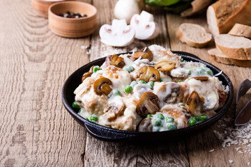 Wall Mural - Chicken and mushroom casserole in cast iron skillet