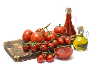 tomatoes and ketchup on a wooden board. 