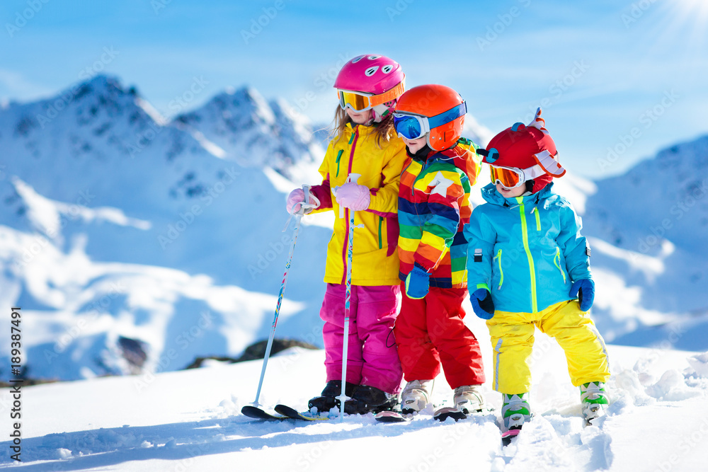 Ski and snow winter fun for kids. Children skiing. - obrazy, fototapety, plakaty 