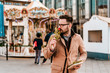© bnenin - Handsome romantic happy man holding and smelling rose.