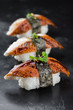 Three Sushi nigiri with eel on black background