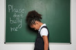 African-American girl near chalkboard with text 