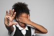 © Africa Studio - Little African-American girl with word 'Stop' on light background