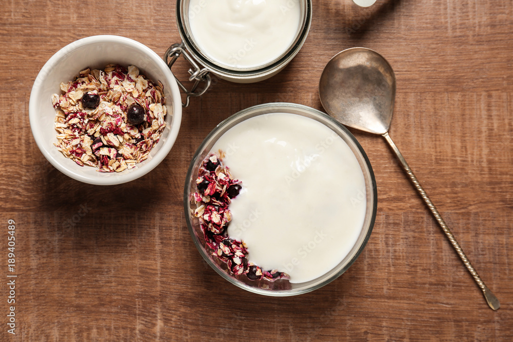 Yogurt with oat flakes and blueberry on wooden table