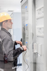Wall Mural - engineer commissioning bay control unit. engineering department