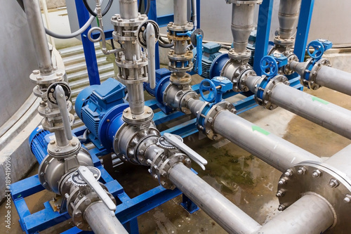 Fotomural Water pump station and pipeline on roof deck of water tank for industrial work